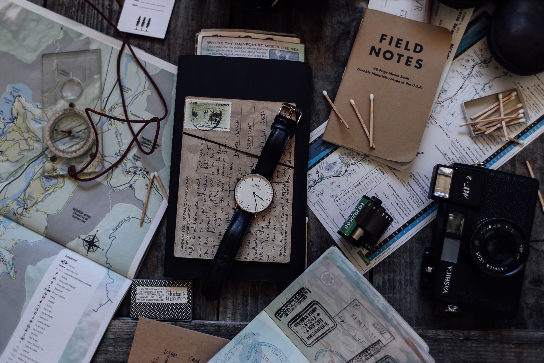 Travel journal writing desk with map and analog camera